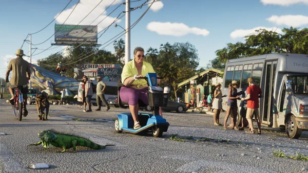 An iguana crosses the road in front of a mobility scooter, a Squalo billboard overhead.