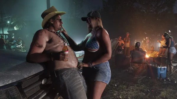 A roadside party at night around a bonfire.