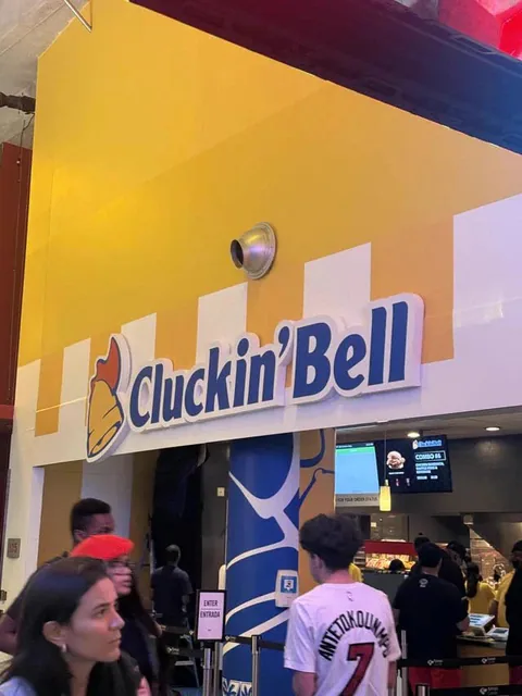 The real-life Cluckin’ Bell food stand inside Miami’s Kaseya Center features a yellow sign with the Cluckin’ Bell logo above the counter.