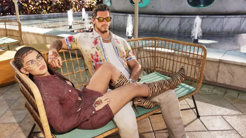 A woman reclines beside a tattooed man on outdoor seating near a swimming pool.