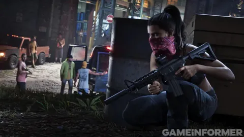 Lucia, masked with a pink bandana, crouches with a rifle behind a barrel as men stand by pickup trucks.