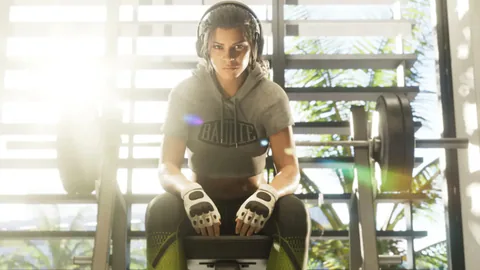 Lucia Caminos sits on a workout bench wearing training gloves and headphones in a sunlit gym.