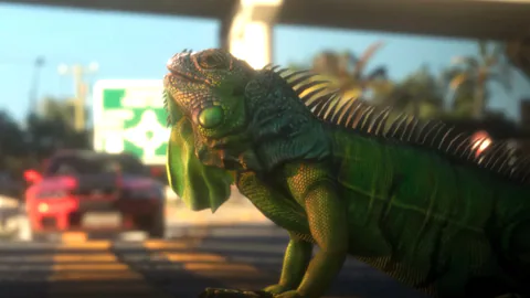 A green iguana stands beside a road in a scene from the Grand Theft Auto VI launch trailer.