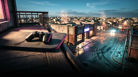 A game controller rests on a rooftop patio overlooking a city of illuminated buildings and wet streets at dusk.