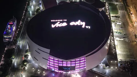 Kaseya Center is illuminated at night with WELCOME TO Vice City VI displayed across its rooftop.