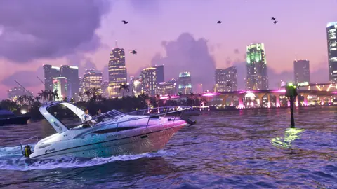 The Shitzu Squalo speedboat in front of a lit city skyline at dusk.