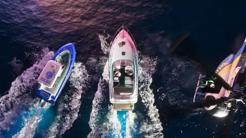 A VICE CITY POLICE boat and a helicopter close in on the Squalo at night.