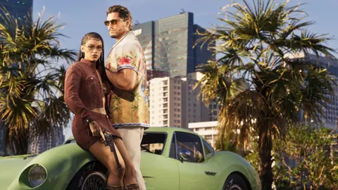 Lucia on a green classic car with her dark revolver, gold hammer and trigger.