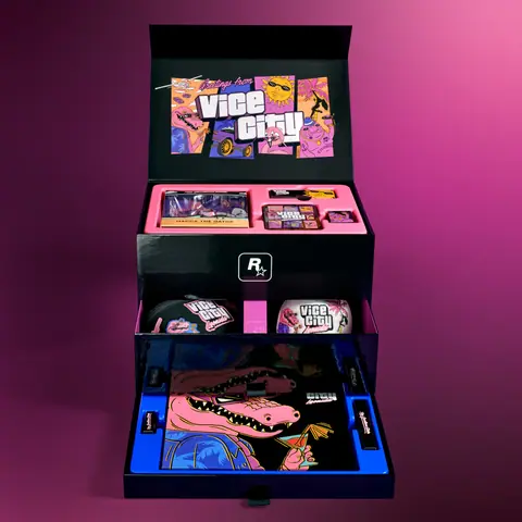 The box open: a Greetings from Vice City lid, trays holding the pin tin and the cap, and a drawer with the Macca mirror.